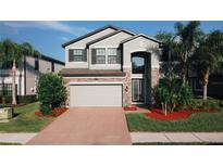 Charming two-story home featuring a brick-accented facade, well-manicured lawn, and a spacious two-car garage at 19314 Long Lake Ranch Blvd, Lutz, FL 33558