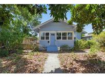 Charming bungalow with light blue exterior, front porch, and mature trees in an established neighborhood at 2710 8Th N Ave, St Petersburg, FL 33713