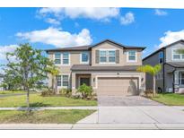 Charming two-story home with a two-car garage and beautifully landscaped front yard, perfect for suburban living at 3113 Marine Grass Dr, Wimauma, FL 33598