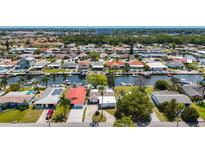 Waterfront community featuring various homes, canals, and lush green landscaping, with easy boating access at 4920 Pelican Dr, New Port Richey, FL 34652
