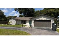 Charming single-story home featuring a two-car garage and well-maintained lawn at 620 Lithia Pinecrest Rd, Brandon, FL 33511