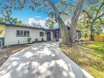 Charming single-story home featuring modern design, complemented by mature trees and a well-maintained front yard at 6901 N 19Th St, Tampa, FL 33610