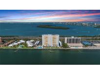 Breathtaking aerial view of waterfront condos, complex pools, and beautiful ocean bay at 7200 Sunshine Skyway S Ln # 4B, St Petersburg, FL 33711