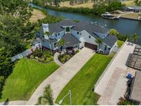 A beautiful two-story waterfront home with lush landscaping and a long driveway at 945 Bunker View Dr, Apollo Beach, FL 33572