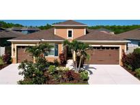 Charming single-Gathering home boasting a well-manicured front yard and a welcoming facade with a three car garage at 1723 Whitewillow Dr, Wesley Chapel, FL 33543