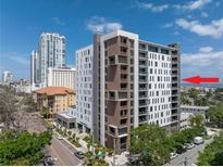 Modern condo building featuring a mix of white and brown panels with private balconies in an urban setting at 199 Dali Blvd # 902, St Petersburg, FL 33701