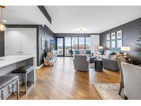 Bright living room with hardwood floors, modern furniture, and expansive windows offering city views at 199 Dali Blvd # 902, St Petersburg, FL 33701