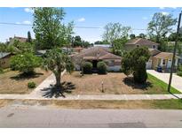 Charming single-story home featuring a quaint front yard with mature trees and a classic design at 3016 W Palmetto St, Tampa, FL 33607