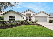 Charming single-story home with a well-manicured lawn and beautifully landscaped flower beds at 3023 Bent Creek Dr, Valrico, FL 33596