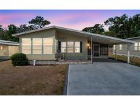 Charming single-story home featuring a covered carport and well-maintained landscaping at 4801 Blanco Dr, Zephyrhills, FL 33541
