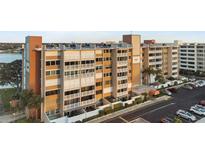 A beautiful condo building featuring covered parking and waterfront views at 500 Treasure Island Cswy # 704, Treasure Island, FL 33706