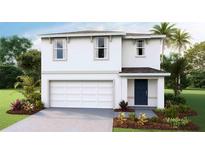 Charming two-story home featuring a white exterior, two car garage and beautifully landscaped front yard at 5236 Salt Marsh Rd, Wimauma, FL 33598