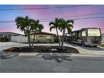 Charming home with palm trees, brick paved driveway, and RV parking at 11340 5Th E St, Treasure Island, FL 33706