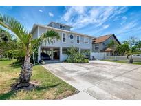Charming stilt home with large driveway and lush tropical landscaping in desirable location at 13974 75Th Ave, Seminole, FL 33776