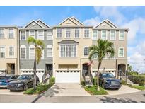 Charming townhomes featuring attached garages, manicured landscaping, and neutral color schemes at 1476 Harbour Walk Rd, Tampa, FL 33602