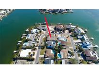 Waterfront home with dock, lush landscaping, and boat lift, offering stunning views and convenient boating access at 2015 Dolphin S Blvd, St Petersburg, FL 33707
