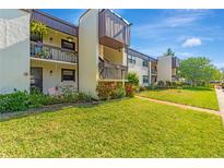 Well-maintained condominium complex with lush landscaping, inviting walkways, and private balconies at 2400 Winding Creek Blvd # 24-102, Clearwater, FL 33761