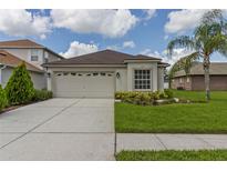 Charming single-story home with a two-car garage, landscaped yard, and neutral exterior at 25830 Crippen Dr, Land O Lakes, FL 34639
