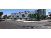 Street view highlighting attractive architecture, mature trees, and overall curb appeal at 20 Outlook Way Blvd # 7, Dunedin, FL 34698