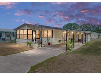 Charming single-story home with a covered parking area, inviting curb appeal, and a cozy front porch at 35051 Colony Hills Dr, Zephyrhills, FL 33541