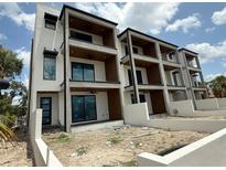 Modern three-story condo featuring covered balconies, sleek design, and a contemporary aesthetic at 501 W Ross Ave # 2, Tampa, FL 33602