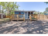 Charming single-story home with wooden deck and fenced yard, offering a cozy and inviting curb appeal at 5304 Cherry Ave, Seffner, FL 33584