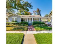 Charming single-story home with manicured lawn, brick walkway, and inviting front porch at 827 S Delaware Ave, Tampa, FL 33606