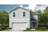 Charming two-story home featuring horizontal siding, a two-car garage, and a welcoming front entrance at 13261 Tropical Breeze Way, Hudson, FL 34669