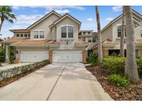 Attractive home exterior boasts a neutral color scheme, well-kept landscaping, and attached two-car garages at 14537 Mirabelle Vista Cir, Tampa, FL 33626