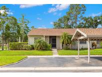 Charming single-story home with well-maintained landscaping and covered parking at 15 Tads Trl, Oldsmar, FL 34677