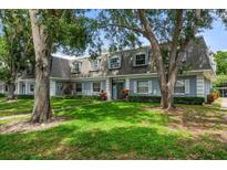 Charming townhome with a well-manicured lawn and mature trees at 1715 Belleair Forest Dr # C, Belleair, FL 33756