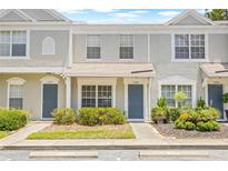 Charming townhouse with landscaped front yard featuring desert plants and grey exterior paint at 2306 Lake Woodberry Cir, Brandon, FL 33511