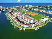 Stunning aerial view of waterfront condos, a marina, and recreational amenities at 250 Medallion Blvd # H, Madeira Beach, FL 33708