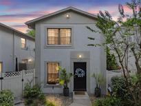 Charming townhouse featuring a black front door, front garden, and welcoming curb appeal at sunset at 310 S Delaware Ave # F, Tampa, FL 33606