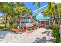 Charming beach house with lush landscaping and a welcoming front porch, perfect for island living at 412 80Th St, Holmes Beach, FL 34217