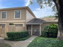 Charming townhome featuring a cozy front porch and lush landscaping, perfect for relaxing outdoors at 11838 Wildeflower Pl # 11838, Temple Terrace, FL 33617