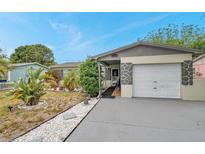 Charming single-story home with a well-maintained lawn and stone accents at 12790 118Th St, Seminole, FL 33778
