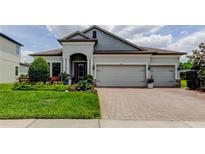 Charming single-story home boasts a three-car garage and professional landscaping at 2826 Riders Pass, Odessa, FL 33556