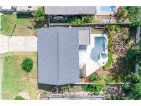 Aerial view of home with a pool, spa, patio, driveway, and landscaping at 320 Crosswinds Dr, Palm Harbor, FL 34683