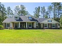 Charming home featuring a well-manicured lawn, classic architectural details, and inviting curb appeal at 5458 Zamia Dr, Brooksville, FL 34604