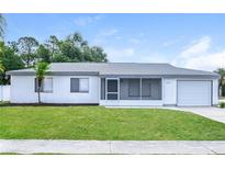 Charming single-story home features a well-maintained lawn, attached garage, and neutral color scheme at 5670 Postma St, North Port, FL 34287