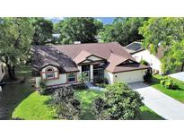 Charming single-story home featuring a well-manicured lawn and mature trees in a serene neighborhood at 8124 Golf Club Ct, Hudson, FL 34667
