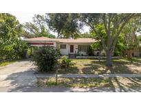 Charming single-story home featuring a well-maintained lawn and mature landscaping at 111 Orangeview Ave, Clearwater, FL 33755