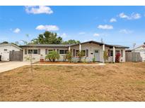 Charming single-story home with well-maintained landscaping and a welcoming, light-blue front door at 1529 79Th N Ave, St Petersburg, FL 33702