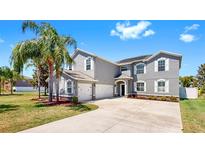 Beautiful two-story home with three-car garage, well-manicured lawn and mature landscaping at 2517 Cumberland Cliff Dr, Ruskin, FL 33570