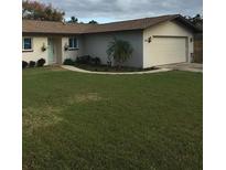 Charming single-story home featuring a well-maintained lawn and inviting curb appeal at 3115 Winchester Dr, Dunedin, FL 34698