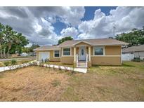 Charming single-story home with neutral stucco, white trim, and well-kept landscaping at 5939 14Th St, Zephyrhills, FL 33542