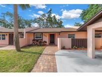 Charming single-story home with a manicured lawn and a brick pathway leading to the front door at 7242 55Th N Ave, St Petersburg, FL 33709