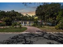 Charming single-story home featuring a brick driveway and lush landscaping at 8239 26Th N Ave, St Petersburg, FL 33710