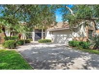 Charming single-Gathering home showcasing a well-manicured lawn, a spacious driveway, and mature trees offering shade at 980 Live Oak Ne Ave, St Petersburg, FL 33703